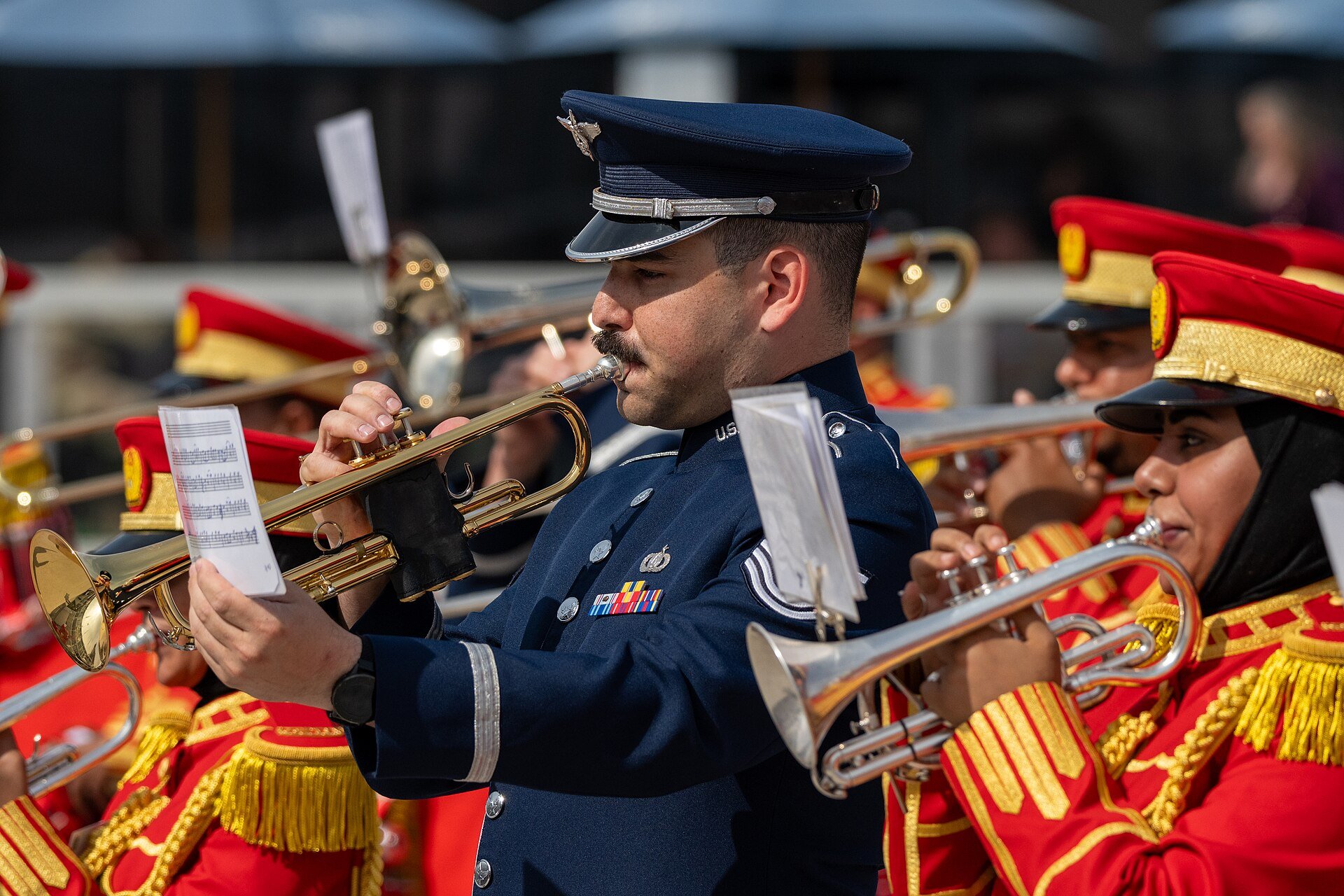 U.S. Air Force Tech. Sgt. Jack Kurtz, 9th Air Force (Air Forces Central) Band trumpeter, and United Arab Emirates Armed Forces Band members perform during the Dubai Airshow 2025 at