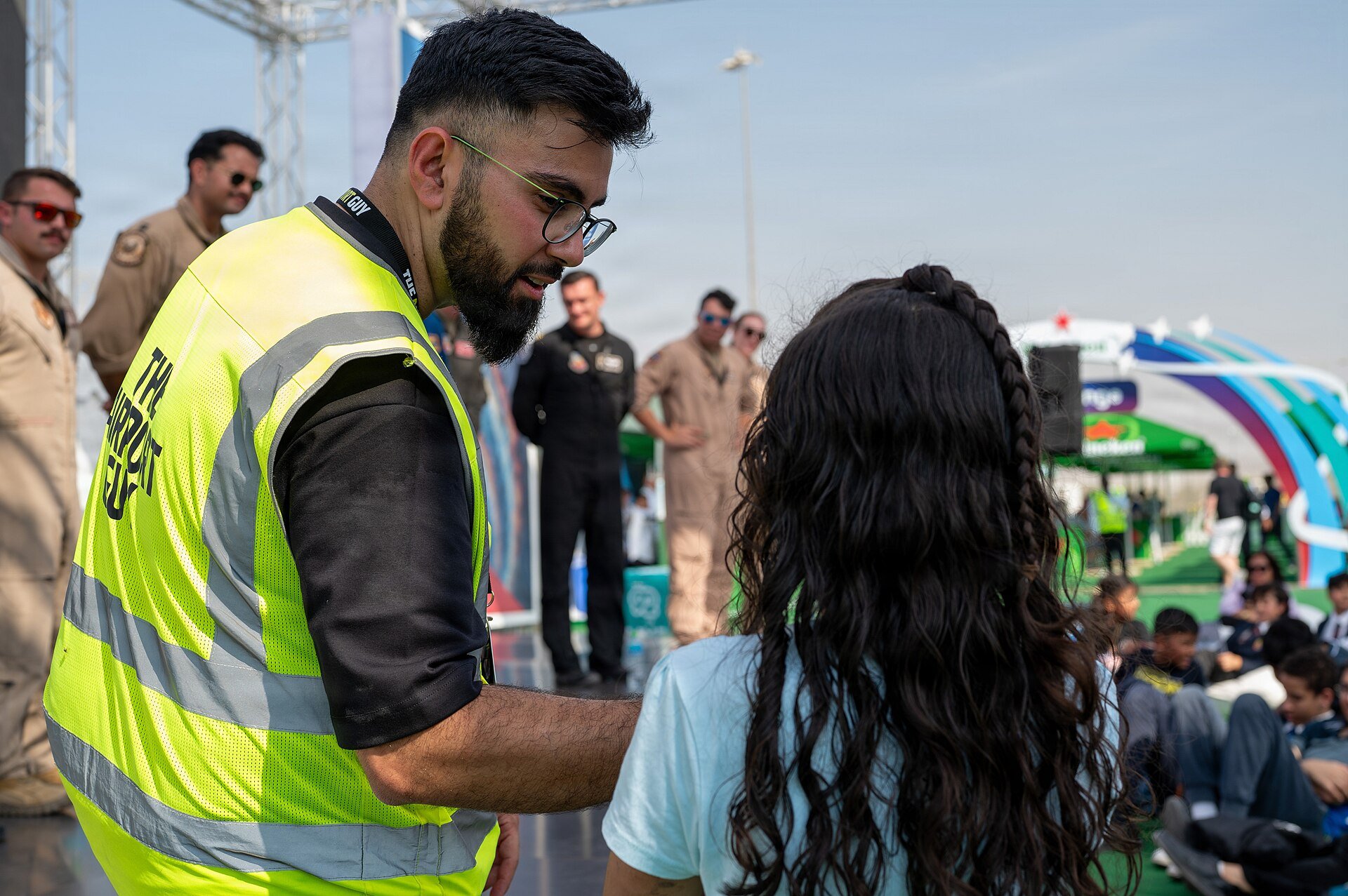 A Dubai Airshow staff member holds a microphone while a student asks a question during the Dubai Airshow 2025 Meet a Pilot question and answer session with U.S. Air Force pilots at